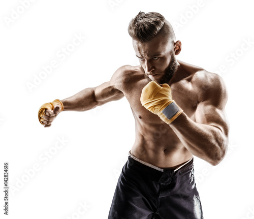 Boxer makes a long side kick - swing. Photo of muscular man on white background. Strength and motivation