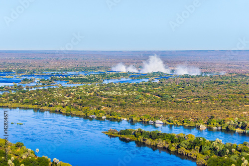 Tableau sur toile Zambezi river and Victoria falls, the largest curtain of water in the world, view from helicopter