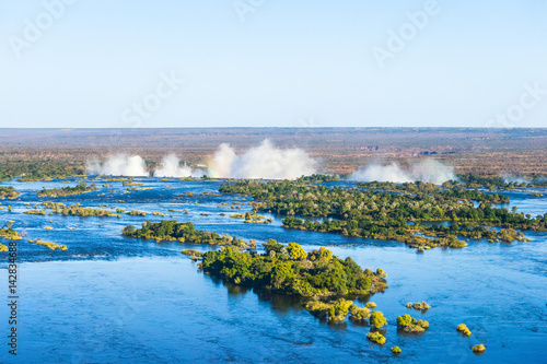Zambezi river and Victoria falls, the largest curtain of water in the world, view from helicopter.