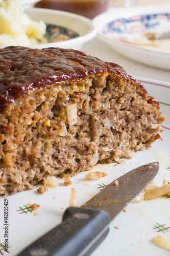 Classic American meatloaf made with ground beef oatmeal onions and a ketchup brown sugar and mustard glaze