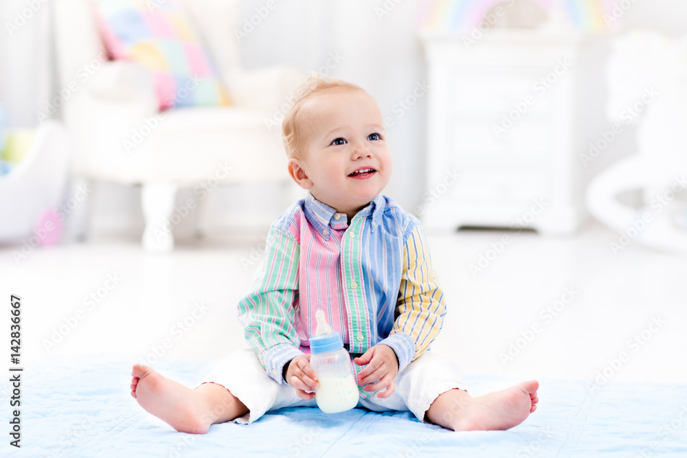 Baby boy with bottle drinking milk or formula Baby boy with bottle drinking milk or formula