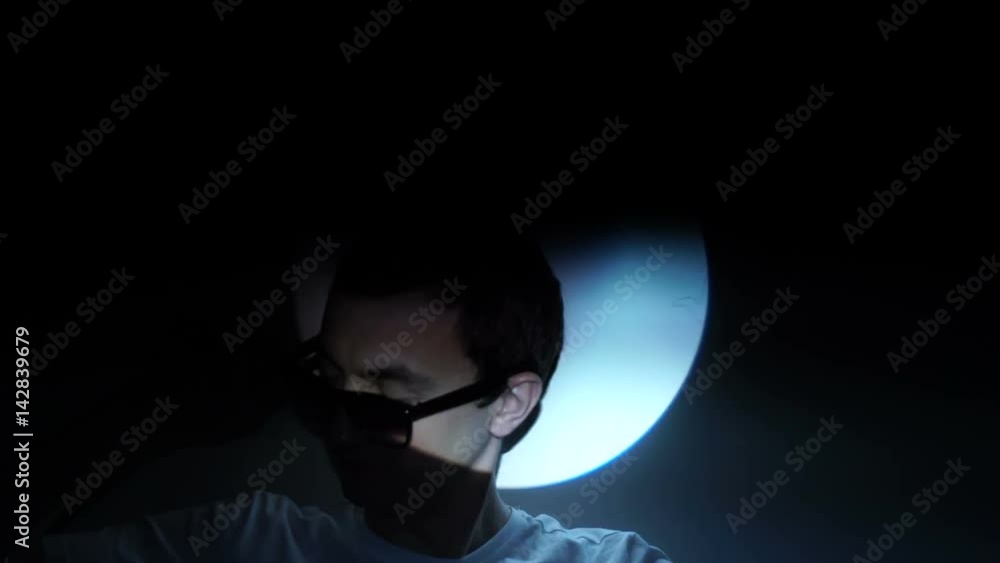 A young man in sunglasses in strobe A young man in sunglasses in strobe