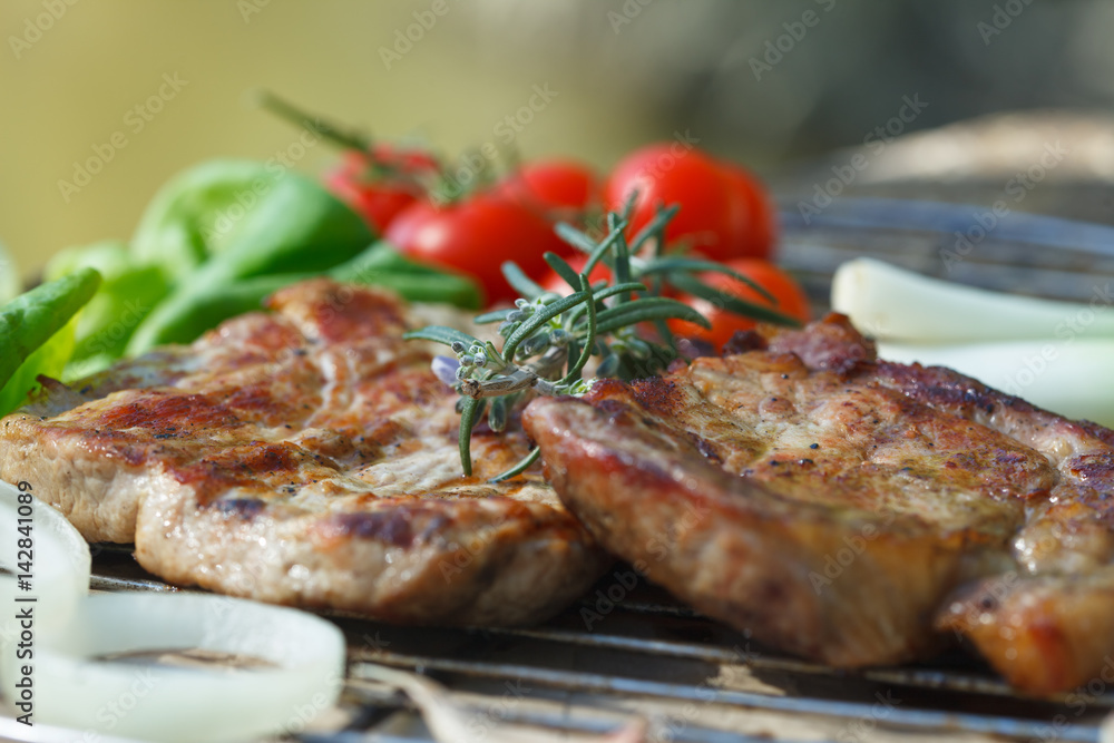 Grilled meat with rosemary and vegetables. Meat from barbecue.