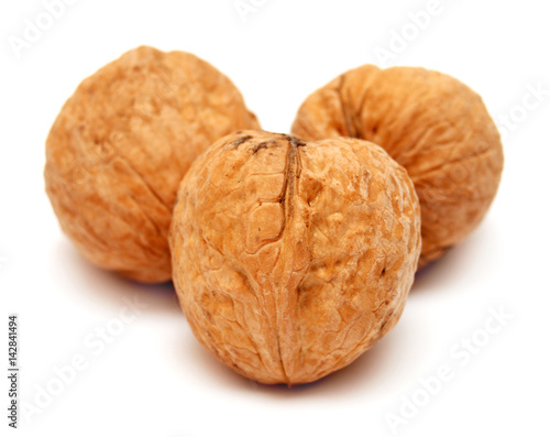 Dry walnuts in shell isolated on white background. Flat lay, top view