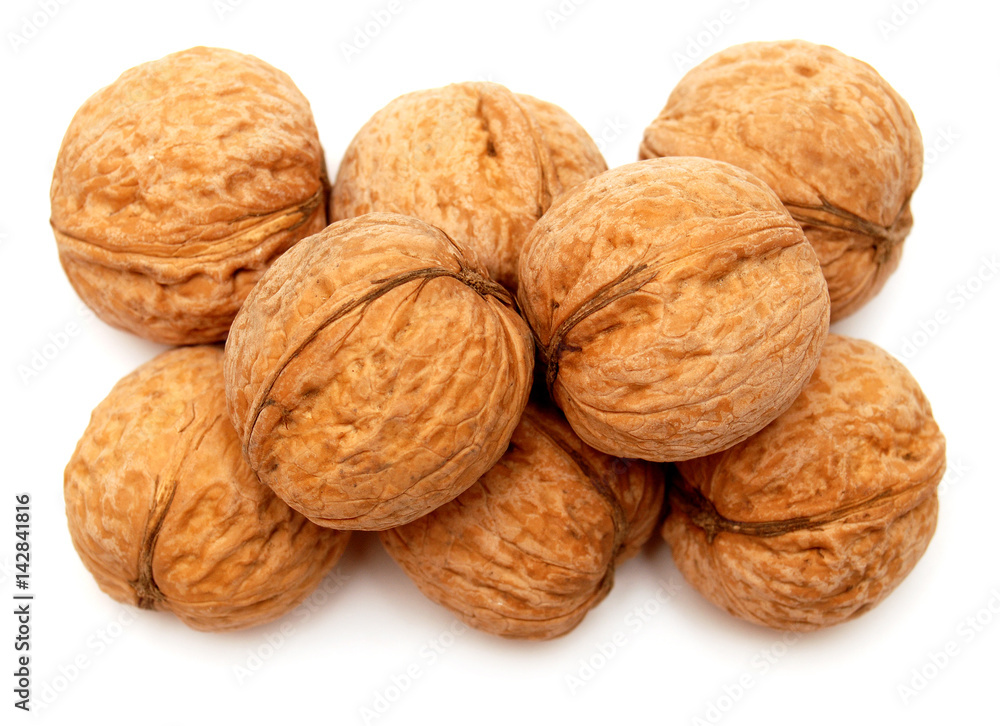 Dry walnuts in shell isolated on white background. Flat lay, top view Dry walnuts in shell isolated on white background. Flat lay, top view
