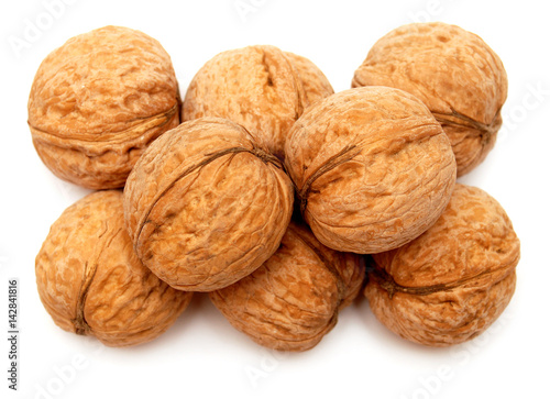 Dry walnuts in shell isolated on white background. Flat lay, top view