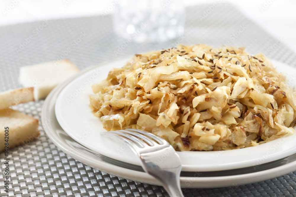 Fried cabbage with caraway and garlic on a plate Fried cabbage with caraway and garlic on a plate