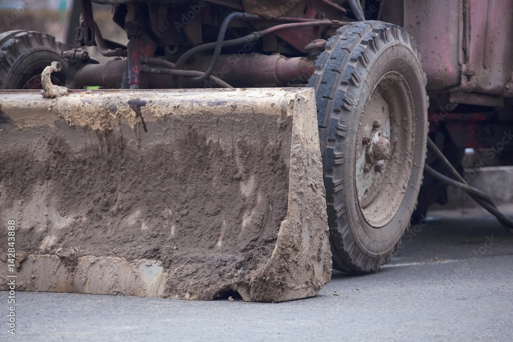 Blade on a tractor standing in the street close up. Blade on a tractor standing in the street close up.