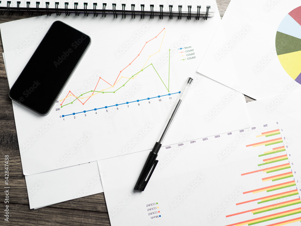 mobile phone with bar chart graph and pen mobile phone with bar chart graph and pen
