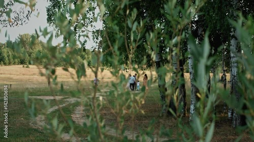 In summer, people with children walk in nature