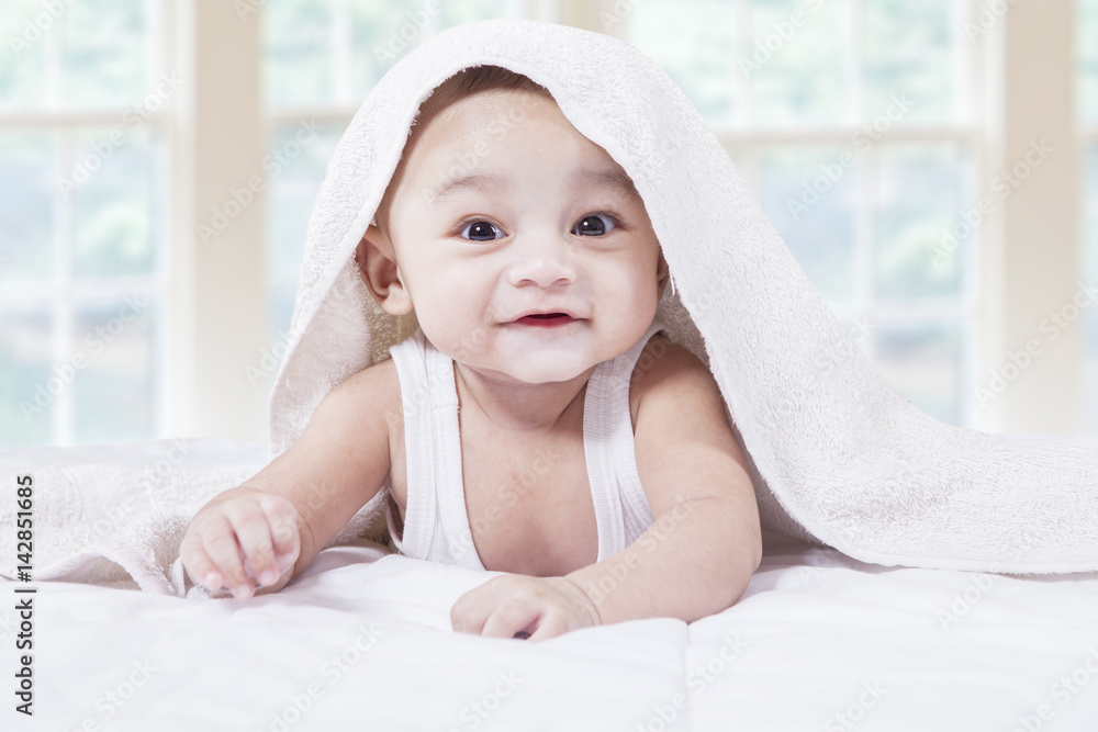 Male toddler with a cute face on bed Male toddler with a cute face on bed