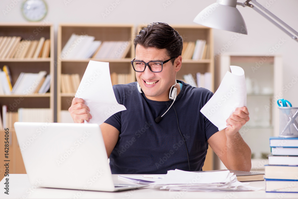 Angry man tearing apart his paperwork due to stress Angry man tearing apart his paperwork due to stress