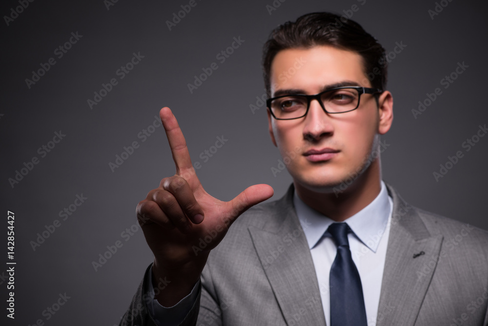 Handsome businessman pressing virtual buttons Handsome businessman pressing virtual buttons