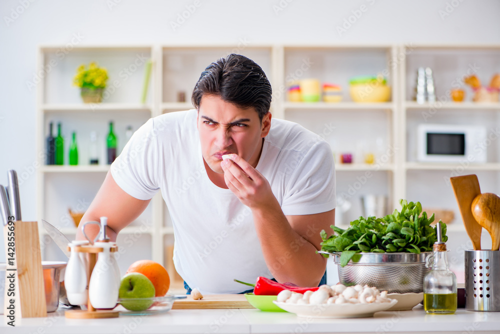 Young male cook working in the kitchen Young male cook working in the kitchen