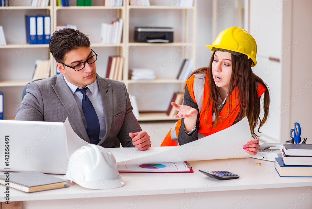 Construction foreman supervisor reviewing drawings Construction foreman supervisor reviewing drawings