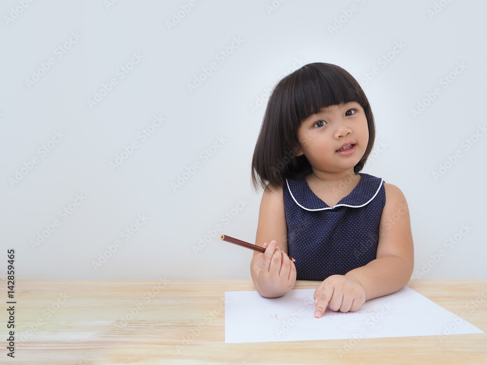 Happy asian kid girl drawing with colored pencil, Child learning and playing at home Happy asian kid girl drawing with colored pencil, Child learning and playing at home