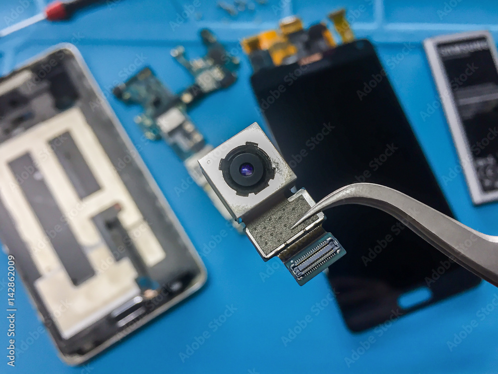 Close-up image of rear camera module on blurred smartphone component background Close-up image of rear camera module on blurred smartphone component background
