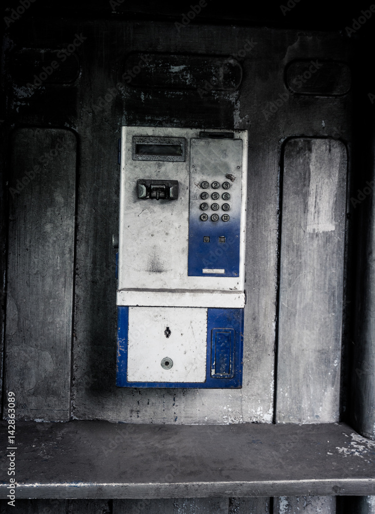 old public telephone machine left with grunge photography style effect photo taken in Jakarta Indonesia