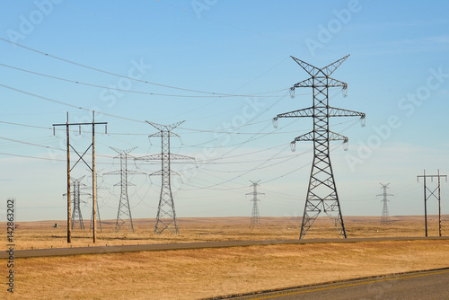 A grid of electric power structures on the prairie