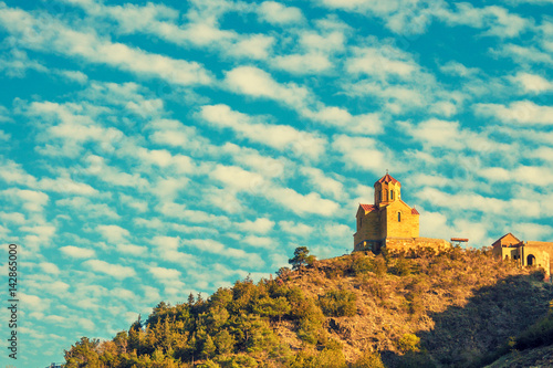 Thabori monastery on a hill with rainbow behind in Tbilisi, Georgia country photo