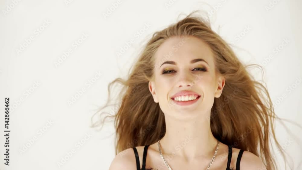 Fashion sensual alluring blond woman in black dress looking at camera over white background Fashion sensual alluring blond woman in black dress looking at camera over white background