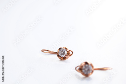 Wallpaper Mural Gold earrings with white gem on white background Torontodigital.ca