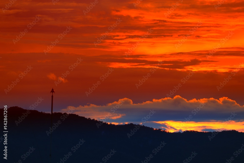 sunset in sky and cloud, beautiful colorful twilight time with mountain silhouette