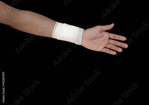 gauze bandage patient with hand wrap injury isolated on black background and clipping path © pramot48