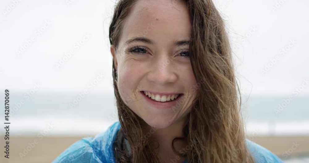 Close up portrait of beautiful teenage girl smiling laughing wet hair blowing in wind in rainy weather slow motion Close up portrait of beautiful teenage girl smiling laughing wet hair blowing in wind in rainy weather slow motion