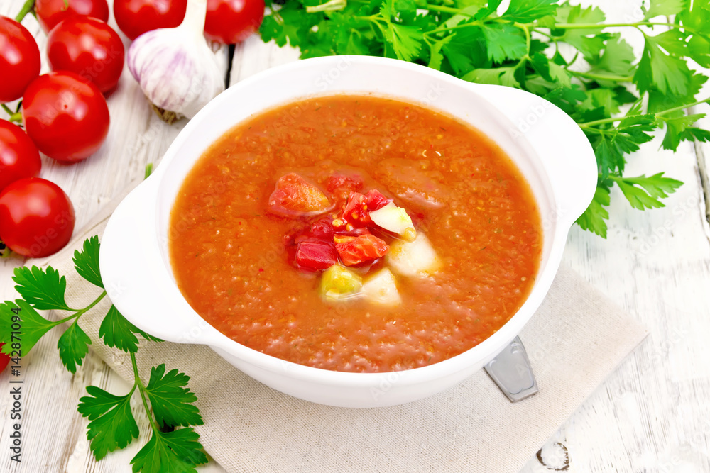 Soup tomato in white bowl on light board Soup tomato in white bowl on light board