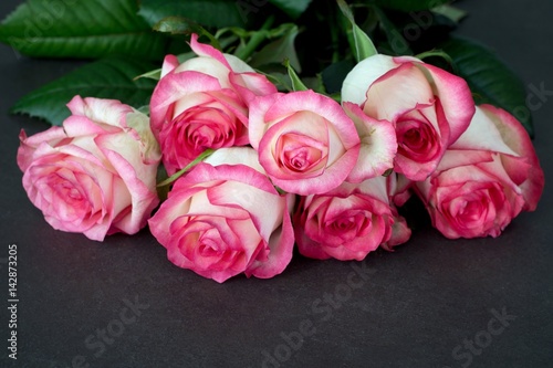 Bouquet of pink and white roses on stone table  closeup view