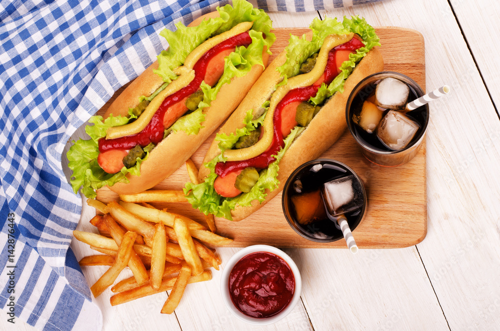 Grilled hot dogs with mustard, ketchup and cucumber Grilled hot dogs with mustard, ketchup and cucumber