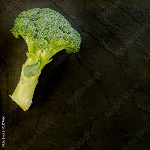 Brocolli on a black slate background photo