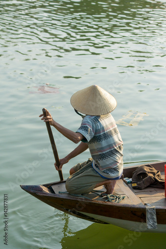 The boatwoman on the old national vietnamese boat