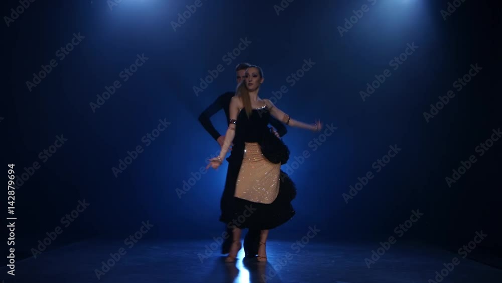 Jive dancing pair of professional elegant dancers in smoky studio Jive dancing pair of professional elegant dancers in smoky studio