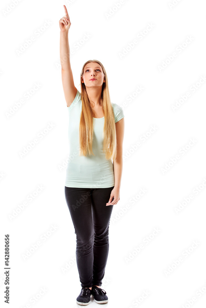 A beautiful girl is pointing up with her hand - isolated on white. A beautiful girl is pointing up with her hand - isolated on white.
