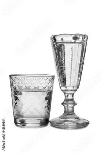 Vodka in a glass and decanter on a white background