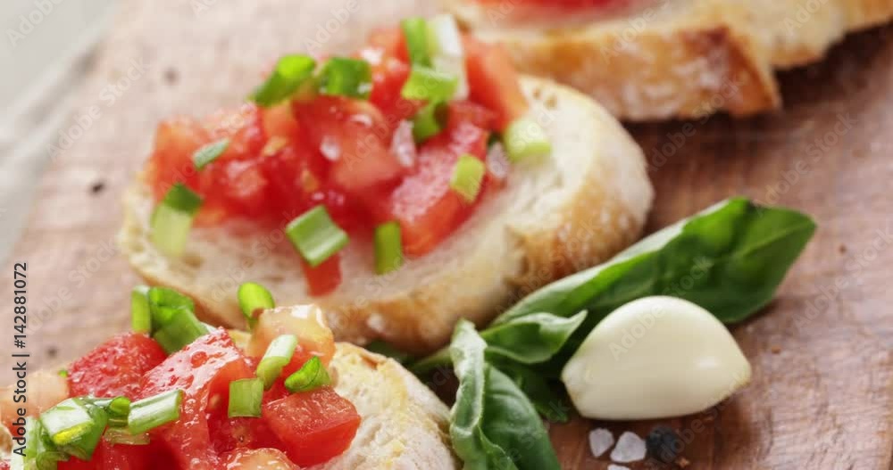 closeup pan of classic italian bruschetta with tomatoes and herbs on wood board, 4k prores footage closeup pan of classic italian bruschetta with tomatoes and herbs on wood board, 4k prores footage