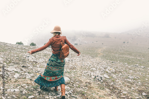 Woman in boho clothing traveling in fog weather