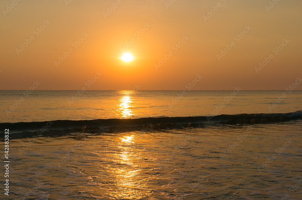 Golden tropical sunrise sky and sand beach