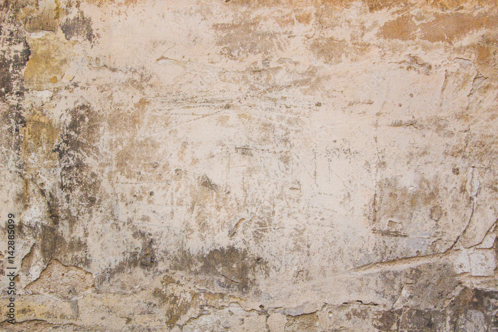 Old grungy wall with damaged plaster abstract horizontal background texture.