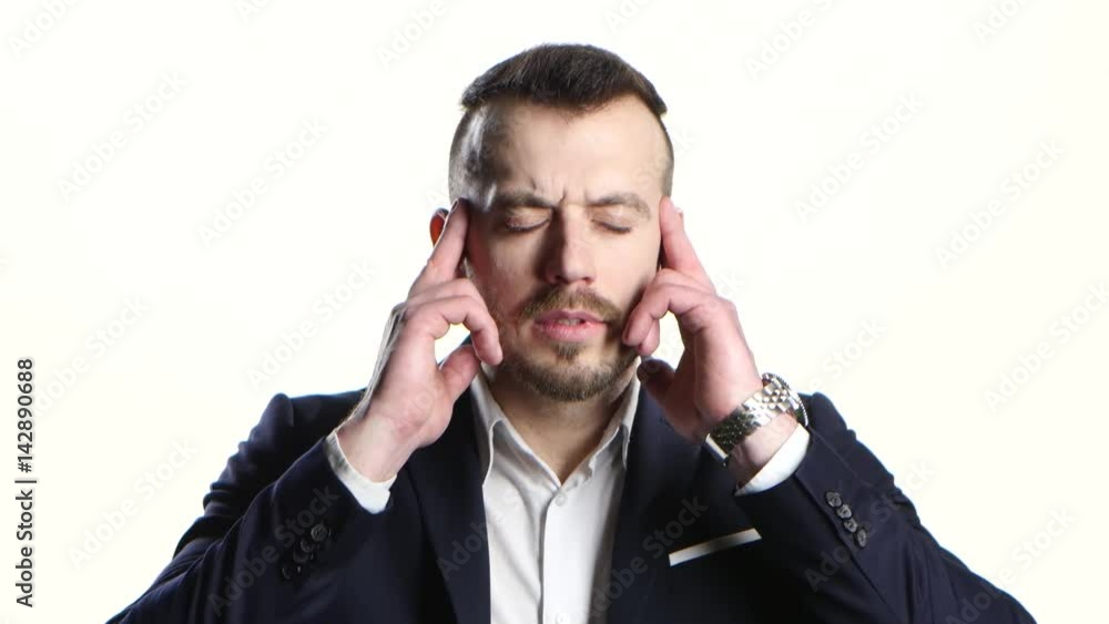 Man in business suit suffers from headache and does massage Man in business suit suffers from headache and does massage
