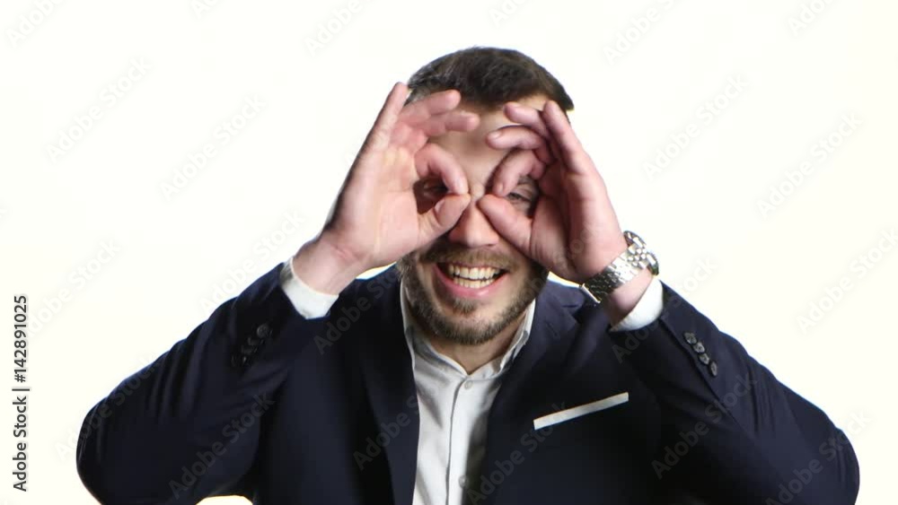 Man fools around and makes funny faces. Close-up, white background Man fools around and makes funny faces. Close-up, white background