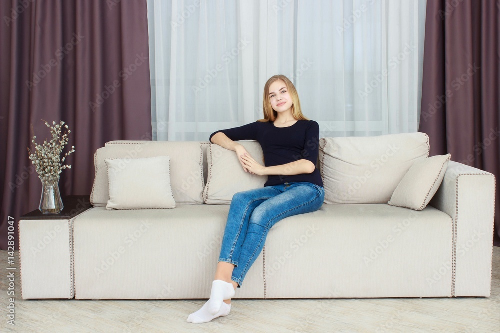 cute young girl relaxing on couch at home