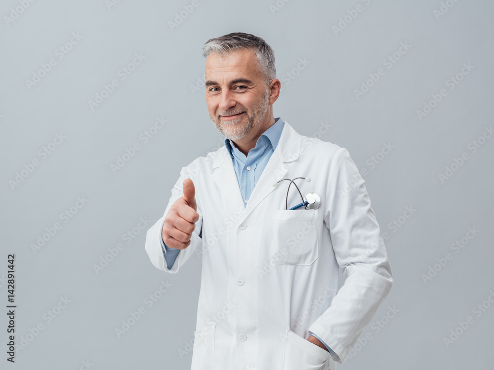 Cheerful doctor giving a thumbs up Cheerful doctor giving a thumbs up