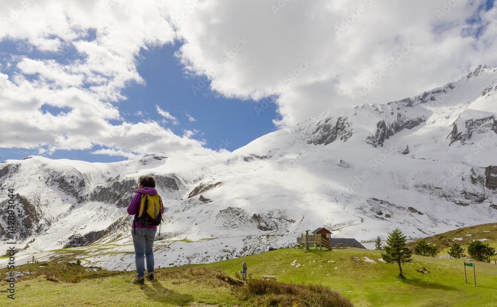 hiker in the Pyrenees mountains in spring with snow