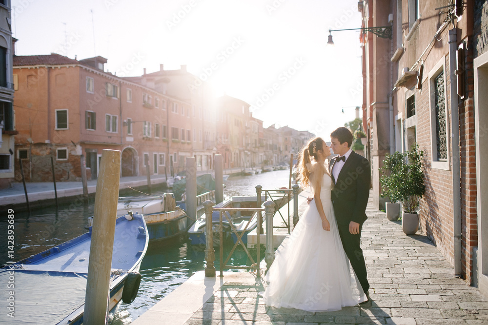 Tender bride and groom in a sunny day in Venice