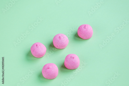 photo of tasty pink marshmallows on the wonderful green studio background