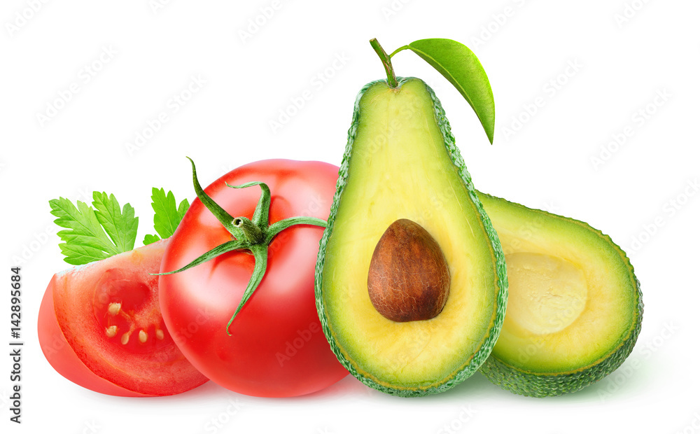 Isolated vegetables. Fresh avocado fruit cut in half and tomatoes isolated on white background with clipping path Isolated vegetables. Fresh avocado fruit cut in half and tomatoes isolated on white background with clipping path