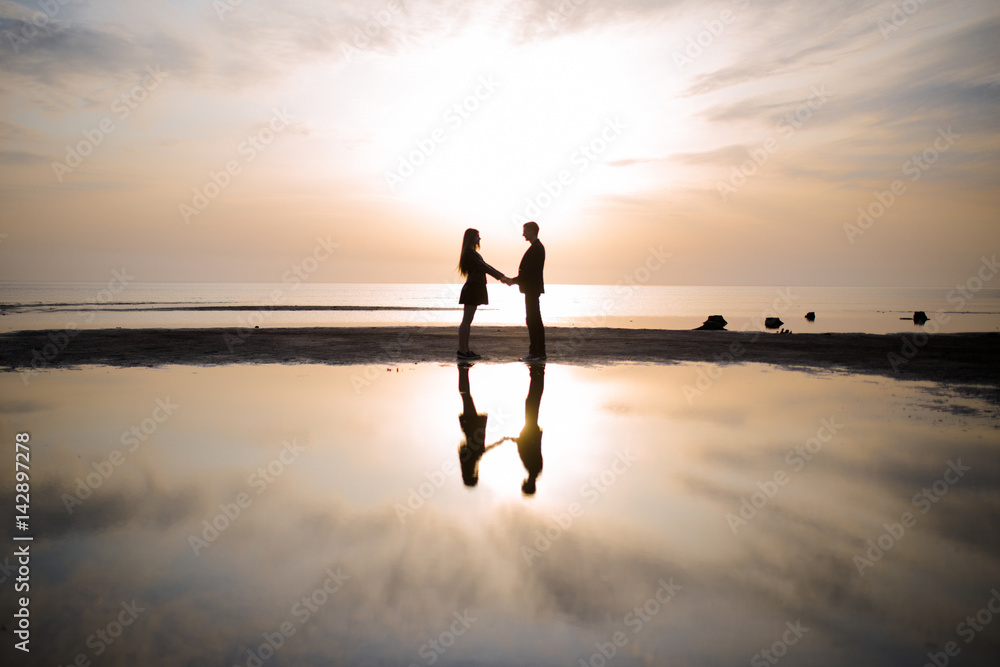 Loving couple silhouetted at sunset
Loving couple silhouetted at sunset